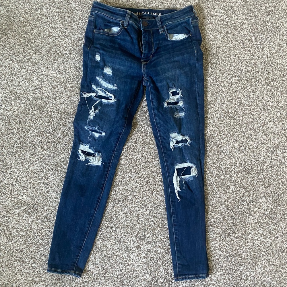 American Eagle covered rips blue jeans